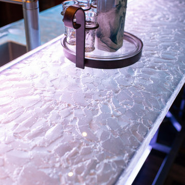 Glass private bar and glass stair treads inside a man cave in Michigan