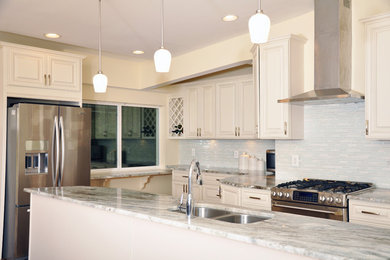 Example of a small classic light wood floor eat-in kitchen design in Baltimore with a double-bowl sink, raised-panel cabinets, white cabinets, granite countertops, white backsplash, glass tile backsplash, stainless steel appliances and an island
