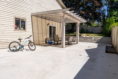 Photo of a mid-sized full sun side yard wood fence landscaping in Vancouver.
