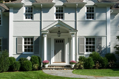 Design ideas for a traditional two-storey brick white exterior in New York.