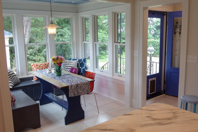 Example of a large transitional u-shaped porcelain tile eat-in kitchen design in Other with a farmhouse sink, flat-panel cabinets, gray cabinets, marble countertops, white backsplash, ceramic backsplash, white appliances and no island