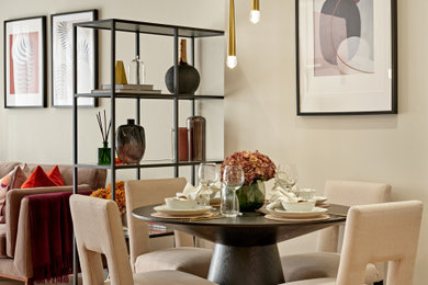 Medium sized contemporary dining room in London with beige walls, medium hardwood flooring and no fireplace.