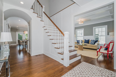 Entryway - mid-sized transitional dark wood floor entryway idea in New York with gray walls and a dark wood front door
