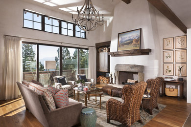 Photo of a country formal living room in Other with grey walls, light hardwood floors, a standard fireplace and a stone fireplace surround.