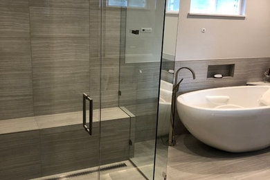 Inspiration for a mid-sized contemporary master bathroom in Sacramento with recessed-panel cabinets, dark wood cabinets, a freestanding tub, a curbless shower, a two-piece toilet, beige tile, porcelain tile, grey walls, porcelain floors, an undermount sink, quartzite benchtops, beige floor, a hinged shower door and white benchtops.