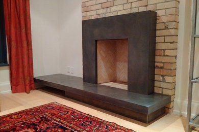 Living room - mid-sized contemporary open concept light wood floor and brown floor living room idea in Toronto with white walls, a standard fireplace, a concrete fireplace and no tv