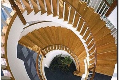 Photo of a large traditional wood floating staircase in Boston with wood risers and wood railing.