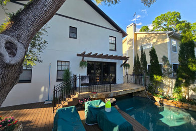 Patio - huge contemporary backyard concrete paver patio idea in Tampa with a roof extension