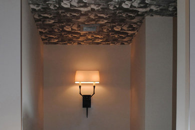 Small minimalist 3/4 light wood floor bathroom photo in New York with flat-panel cabinets, white cabinets, a one-piece toilet, beige walls, an integrated sink and solid surface countertops