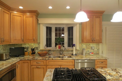 Inspiration for a mid-sized timeless u-shaped ceramic tile open concept kitchen remodel in DC Metro with an undermount sink, shaker cabinets, light wood cabinets, granite countertops, green backsplash, mosaic tile backsplash, stainless steel appliances and an island
