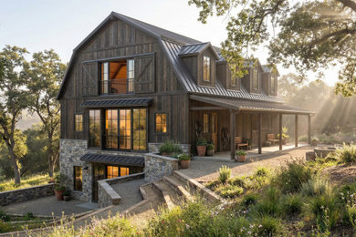 Large farmhouse brown three-story wood and board and batten house exterior idea in Los Angeles with a gambrel roof, a metal roof and a gray roof