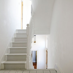 Design ideas for a classic painted wood u-shaped staircase in London with painted wood risers.