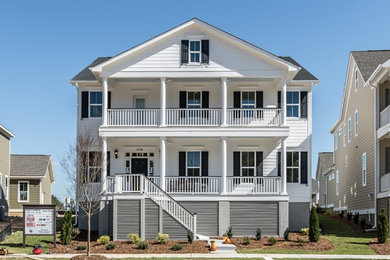 Large elegant white two-story concrete fiberboard gable roof photo in Raleigh