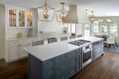 Large transitional dark wood floor and brown floor eat-in kitchen photo in Bridgeport with an undermount sink, shaker cabinets, blue cabinets, quartzite countertops, white backsplash, subway tile backsplash, stainless steel appliances, an island and white countertops