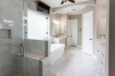 Example of a large minimalist master gray tile and ceramic tile ceramic tile, gray floor and double-sink bathroom design in Houston with shaker cabinets, gray cabinets, a two-piece toilet, gray walls, an undermount sink, quartz countertops, a hinged shower door, white countertops and a built-in vanity