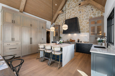 Inspiration for a cottage u-shaped medium tone wood floor, brown floor, exposed beam, vaulted ceiling and wood ceiling kitchen remodel in Other with an undermount sink, shaker cabinets, light wood cabinets, white backsplash, stainless steel appliances, an island and white countertops