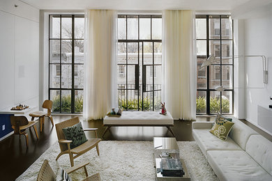 Inspiration for a large modern living room in New York with white walls and concrete floors.