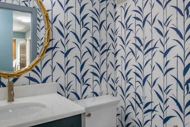 Powder room - mid-sized transitional ceramic tile and wallpaper powder room idea in Richmond with blue cabinets, an undermount sink, marble countertops and white countertops