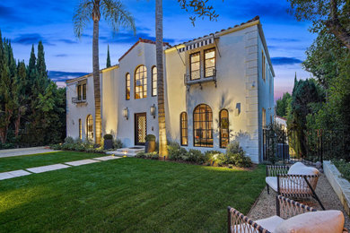 Example of a mid-sized tuscan three-story stucco house exterior design in Los Angeles