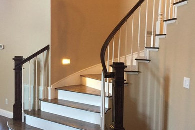 Design ideas for a large traditional wood curved staircase in Sacramento with painted wood risers and wood railing.