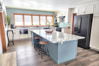 Eat-in kitchen - mid-sized transitional l-shaped vinyl floor eat-in kitchen idea in Other with an undermount sink, flat-panel cabinets, quartz countertops, glass tile backsplash, black appliances and an island