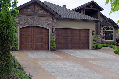 Mid-sized arts and crafts attached two-car garage photo in Other