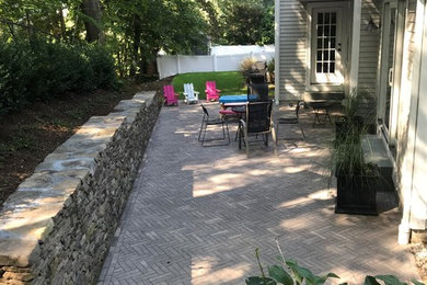 Inspiration for a modern patio in Boston with concrete pavers.