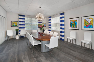 Example of a trendy light wood floor dining room design in Tampa with white walls and no fireplace