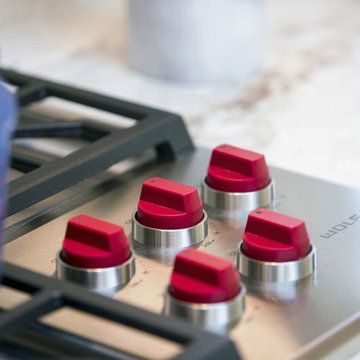 Stainless Steel Stove Top with Red Accent Knobs