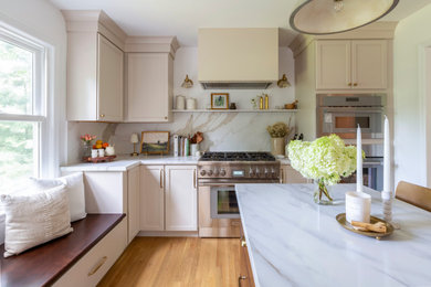 Inspiration for a mid-sized timeless l-shaped medium tone wood floor kitchen pantry remodel in New York with an undermount sink, shaker cabinets, quartz countertops, white backsplash, porcelain backsplash, stainless steel appliances, an island and white countertops