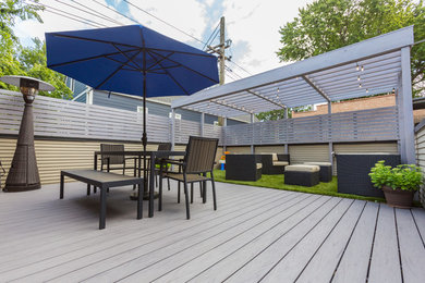 Deck - large contemporary rooftop deck idea in Chicago with a pergola