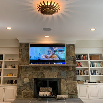 Samsung 65' FRAME Art Panel over Stone Fireplace with surround system