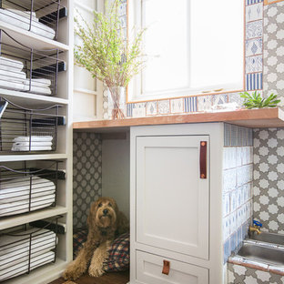Photo of a medium sized beach style utility room in Los Angeles with shaker cabinets, grey cabinets, wood worktops, white walls and dark hardwood flooring.