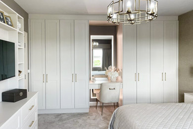 Photo of a medium sized modern wardrobe in Other with shaker cabinets and feature lighting.