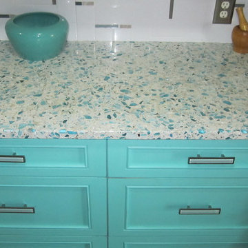 Floating Blue Vetrazzo and Teal Cabinetry