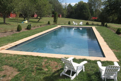 Pool - backyard concrete paver and rectangular lap pool idea in Other