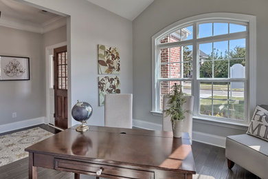 Example of a mid-sized transitional freestanding desk dark wood floor study room design in San Diego with gray walls