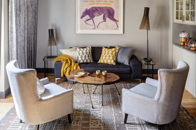 Inspiration for a transitional formal living room in London with grey walls.