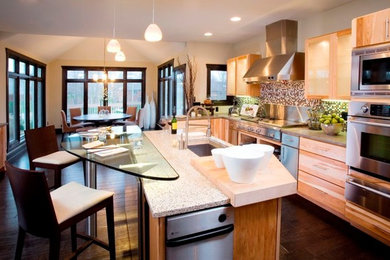 Inspiration for a large contemporary eat-in kitchen in Indianapolis with a single-bowl sink, flat-panel cabinets, light wood cabinets, multi-coloured splashback, stainless steel appliances, dark hardwood floors and with island.