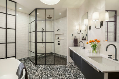 Design ideas for an industrial master bathroom in Minneapolis with glass-front cabinets, black cabinets, a freestanding tub, a curbless shower, a one-piece toilet, white tile, subway tile, white walls, porcelain floors, an undermount sink, engineered quartz benchtops, white benchtops, a double vanity, a floating vanity and wallpaper.