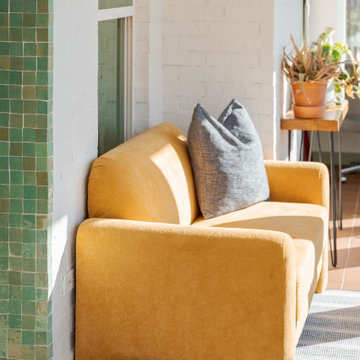 Arched Built-Ins Meet Terracotta Tile in a Light-Filled Sunroom Addition