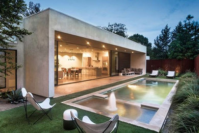 Inspiration for a large modern backyard rectangular lap pool in Dallas with a hot tub and concrete slab.