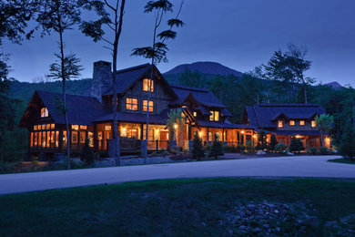 Example of a large mountain style three-story exterior home design in Burlington with a shed roof