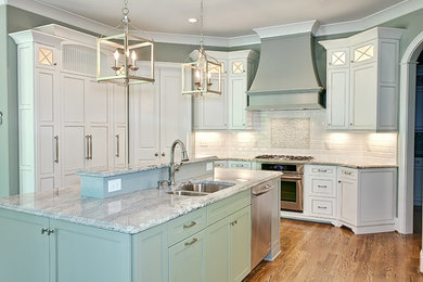 Inspiration for a timeless u-shaped open concept kitchen remodel in St Louis with an undermount sink, gray cabinets, white backsplash, stainless steel appliances and an island