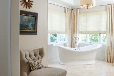 Design ideas for a large traditional master bathroom in Detroit with a freestanding tub and beige walls.