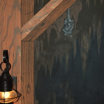 The Bat Cave Themed Mural in a stairway and lower level by Tom Taylor