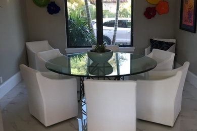 Example of a trendy enclosed dining room design in Miami with white walls
