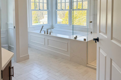 Bathroom - large traditional master porcelain tile, white floor and wainscoting bathroom idea in Boston with shaker cabinets, medium tone wood cabinets, an undermount tub, white walls, quartz countertops, a hinged shower door, white countertops and a built-in vanity