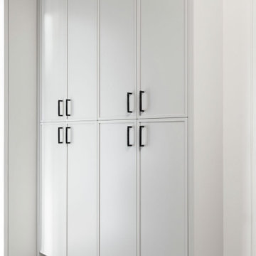 Tall White Custom Cabinetry and Stacked Appliances Create a Functional Laundry O