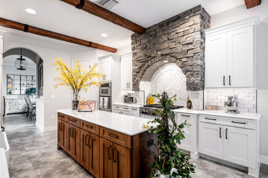 Large transitional galley porcelain tile and gray floor eat-in kitchen photo in Tampa with a farmhouse sink, shaker cabinets, white cabinets, quartz countertops, white backsplash, porcelain backsplash, stainless steel appliances, an island and white countertops